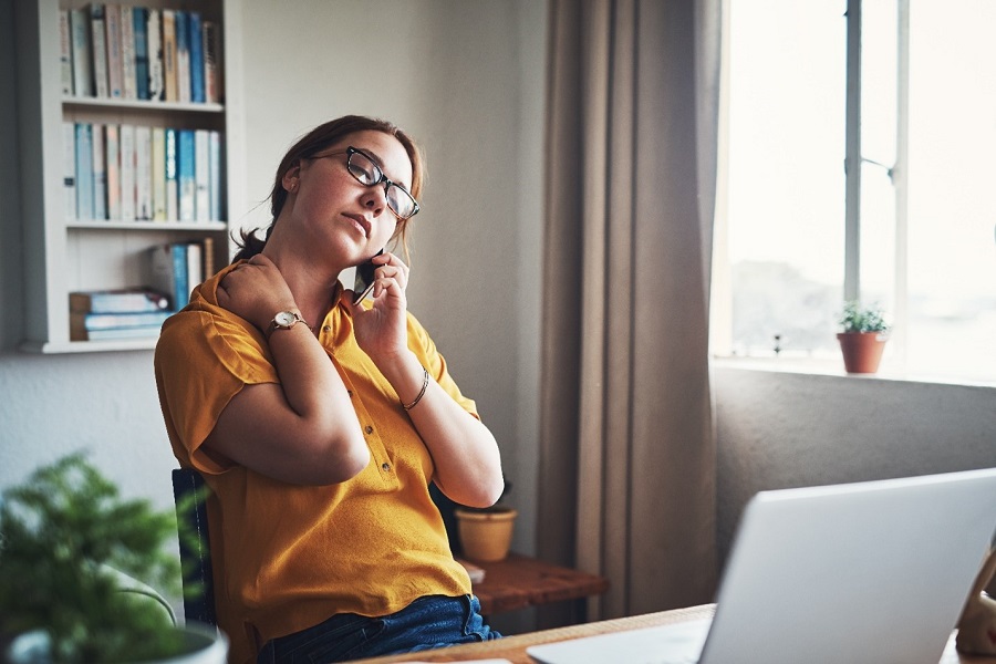 A woman waiting while on the phone